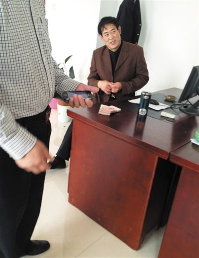 10月29日，獻(xiàn)縣國稅局稽查局辦公室內(nèi)，一名企業(yè)主交了兩萬元現(xiàn)金在桌上。新京報記者 孟祥超 攝