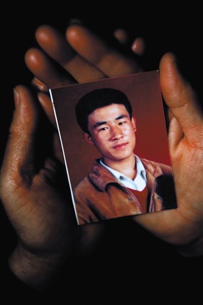 尚愛云捧著兒子的照片。
